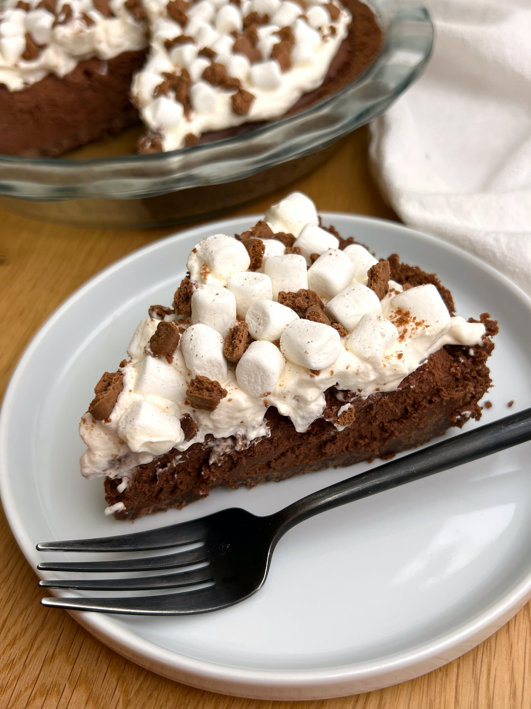Slice of Hot Chocolate Pie on White Plate with Black Fork