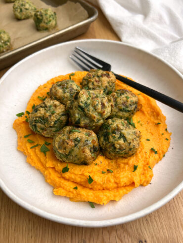 Gluten Free Sage Chicken Meatballs with Sweet Potato Carrot Mash on white plate with black fork