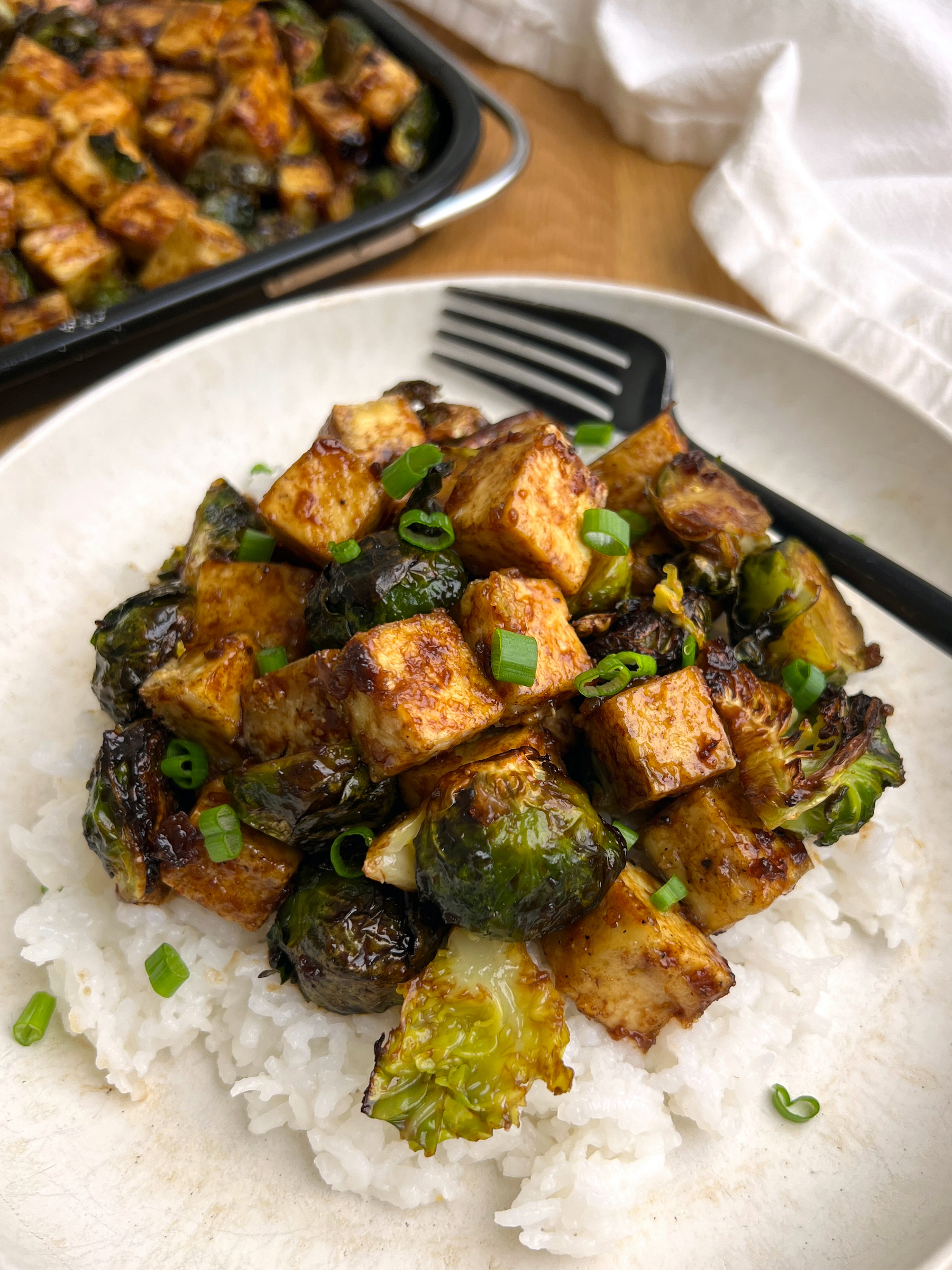 Air Fryer Balsamic Tofu & Brussels Sprouts Bowl over White Rice with black fork