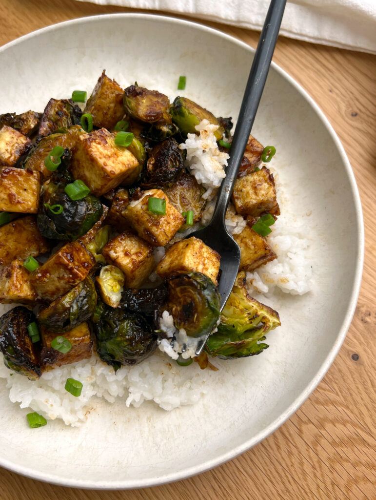Air Fryer Balsamic Tofu & Brussels Sprouts Bowl over white rice with black fork