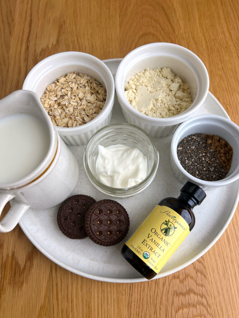 Ingredients for cookies and cream overnight oats on a white plate