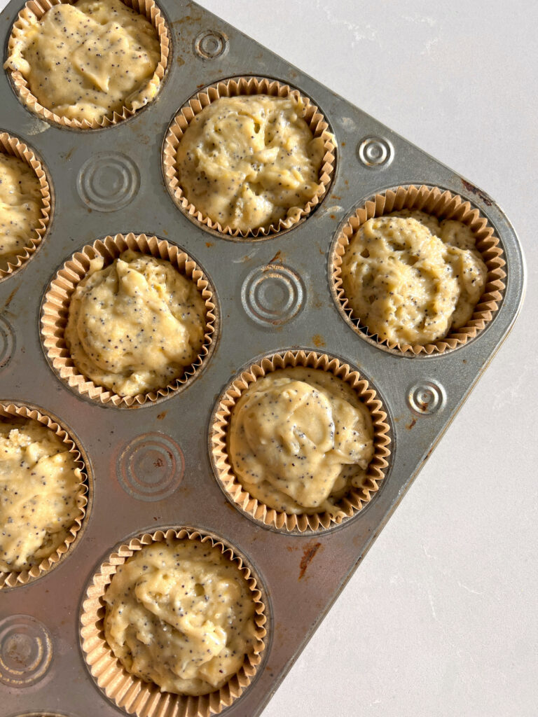 gluten free lemon poppyseed muffins in muffin tin before being baked