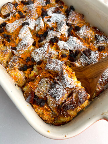 spatula taking a square of Dairy free carrot cake French toast casserole out of the baking dish