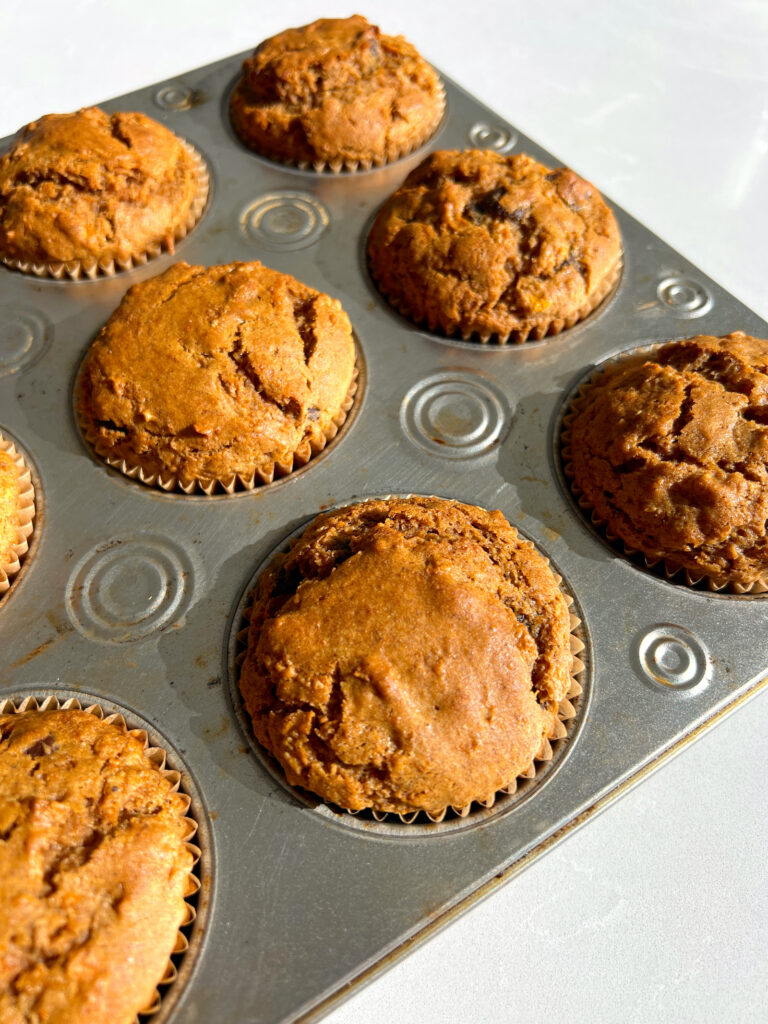 Gluten Free Carrot Cake Muffins with Chocolate Chips in muffin tin after being baked