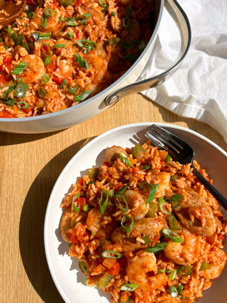 15-Minute Healthy Jambalaya Recipe on white plate with black fork and pan in the background