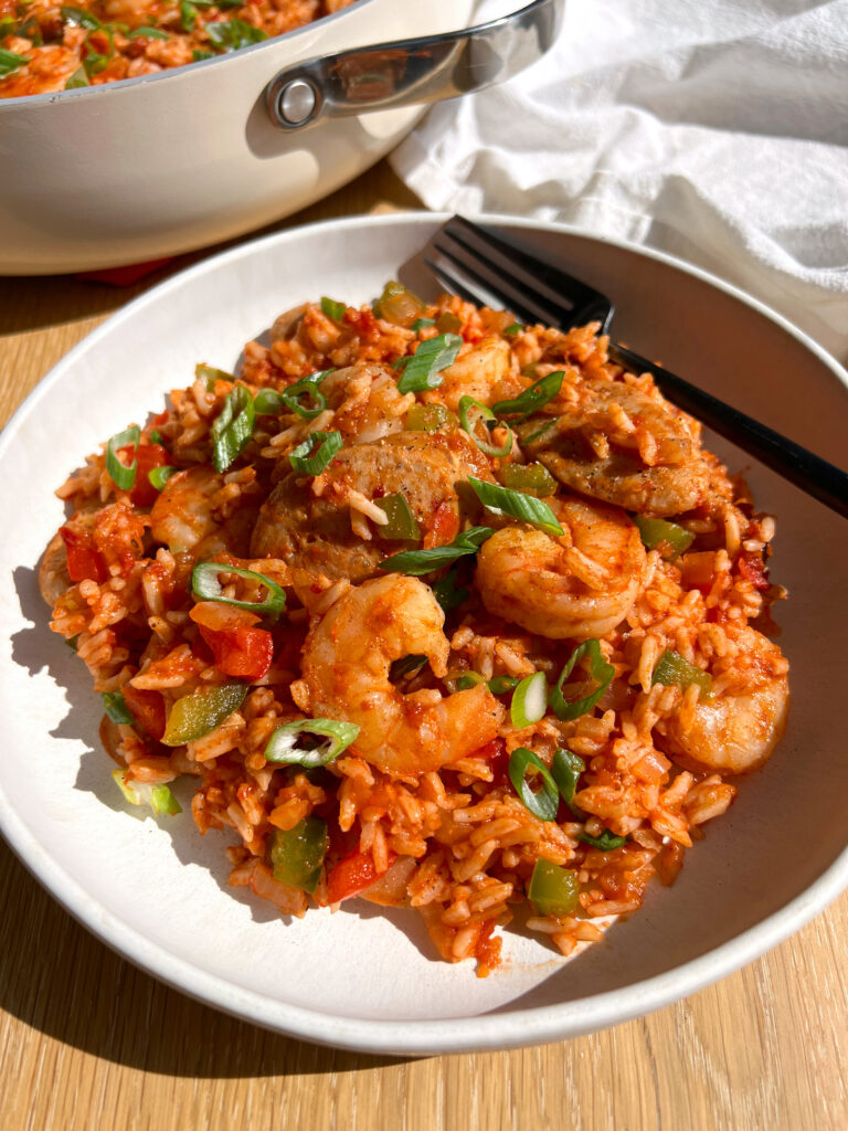 15-Minute Healthy Jambalaya Recipe on white plate with black fork and pan in the background