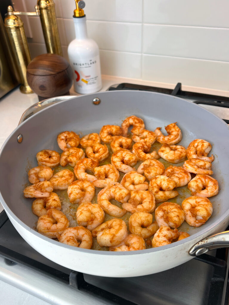 shrimp sautéing in large pan