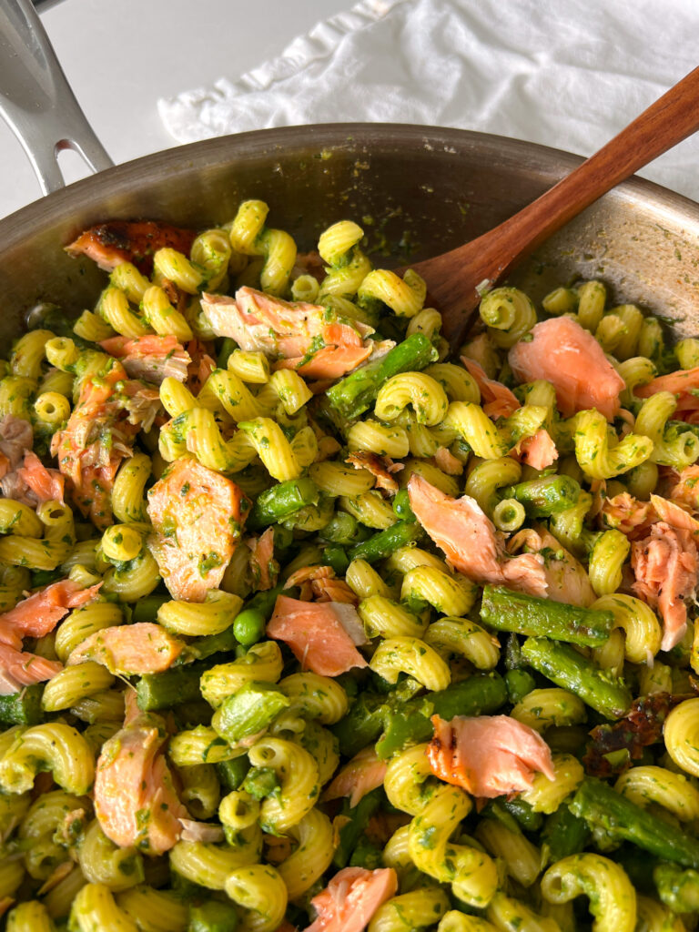 Salmon Pea Pasta with Asparagus in pan with wooden spatula